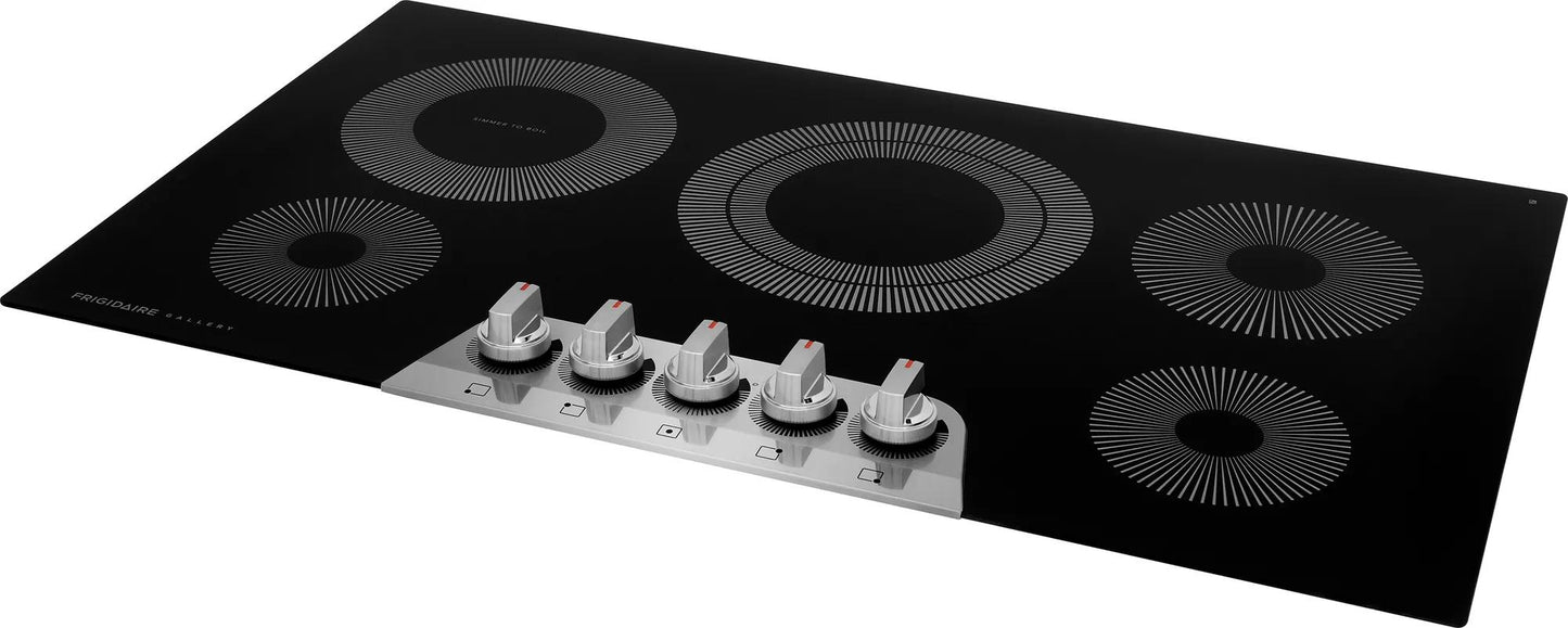Black glass 36-inch electric cooktop with five front-mounted silver control knobs and radiant heating elements from cooktops collection