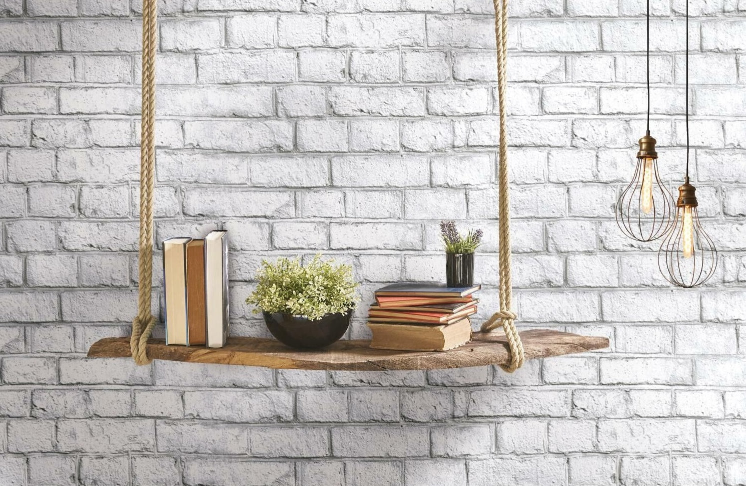Rustic wooden swing shelf with books and plants against whitewash brick peel and stick wallpaper backdrop