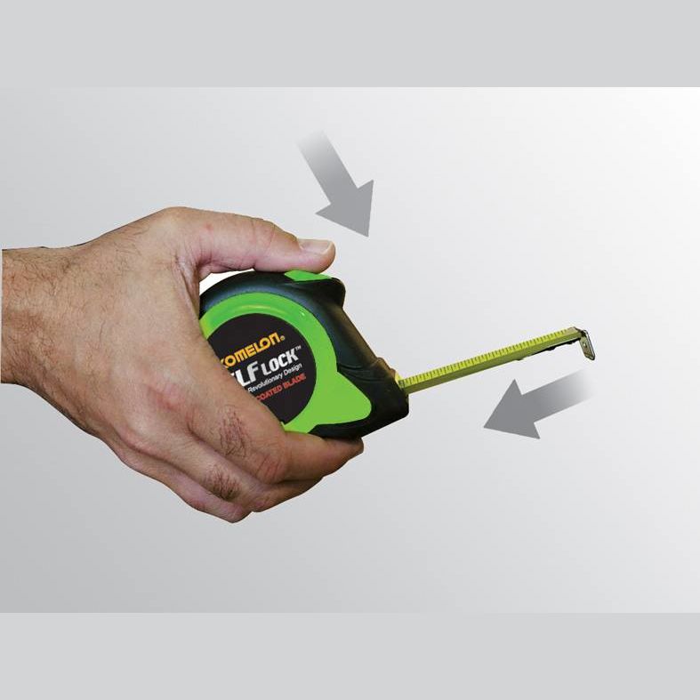 Hand holding green and black Komelon Self Lock tape measure with extended yellow nylon-coated blade measuring tools