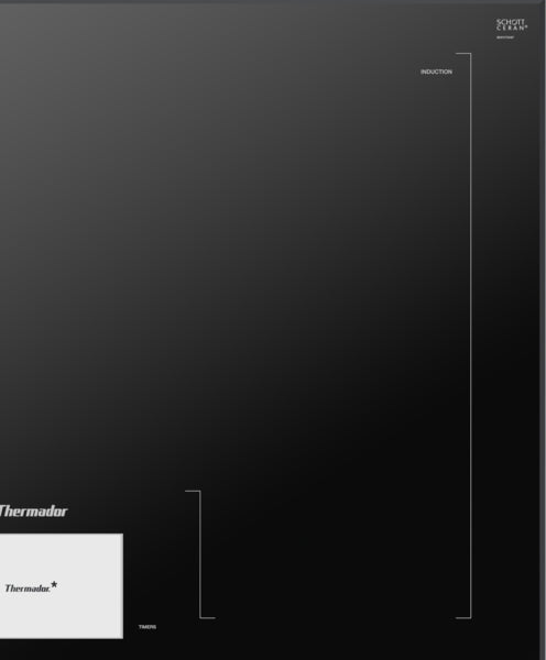 Dark gray induction cooktop surface with minimal markings from Thermador in the kitchen appliances collection.