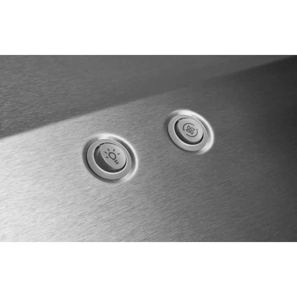 Close-up of stainless steel range hood control panel with LED light and fan speed buttons in kitchen appliances collection