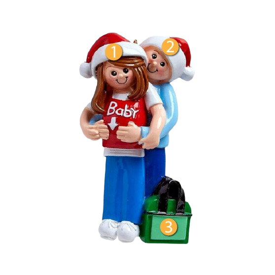 Couple in Santa hats hugging with red shirt reading Baby and green gift bag from Christmas decor collection