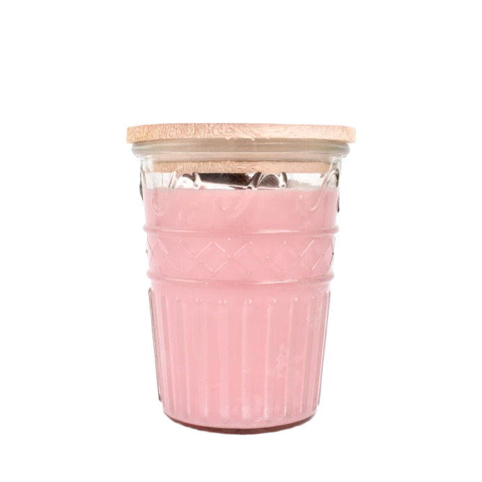 Pink wax candle in textured clear glass jar with wooden lid for home ambiance and decor
