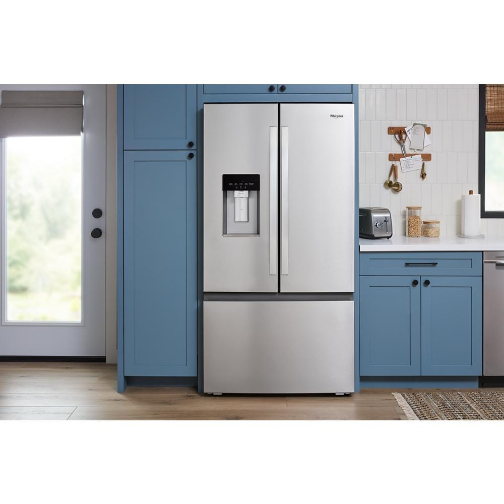 Stainless steel French door refrigerator with bottom freezer and in-door water and ice dispenser in modern kitchen setting