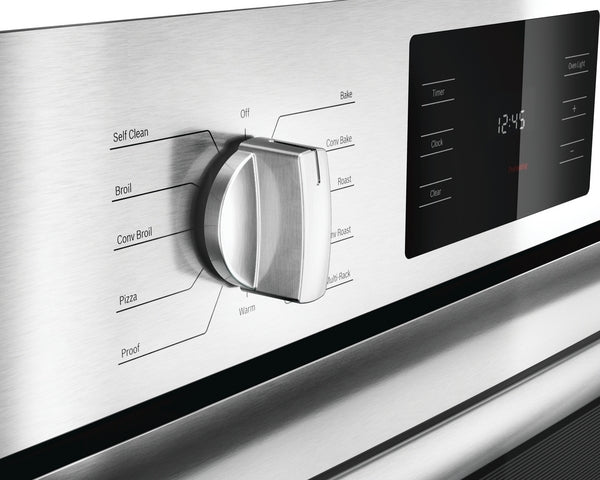 Close-up of stainless steel wall oven control knob and digital display panel showcasing cooking mode options in modern kitchen appliances collection