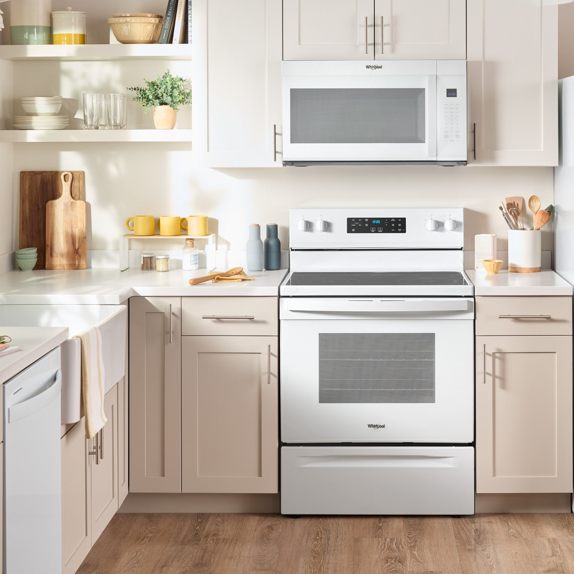 White over the range microwave with digital display and sensor cooking installed above white electric range in modern kitchen setting