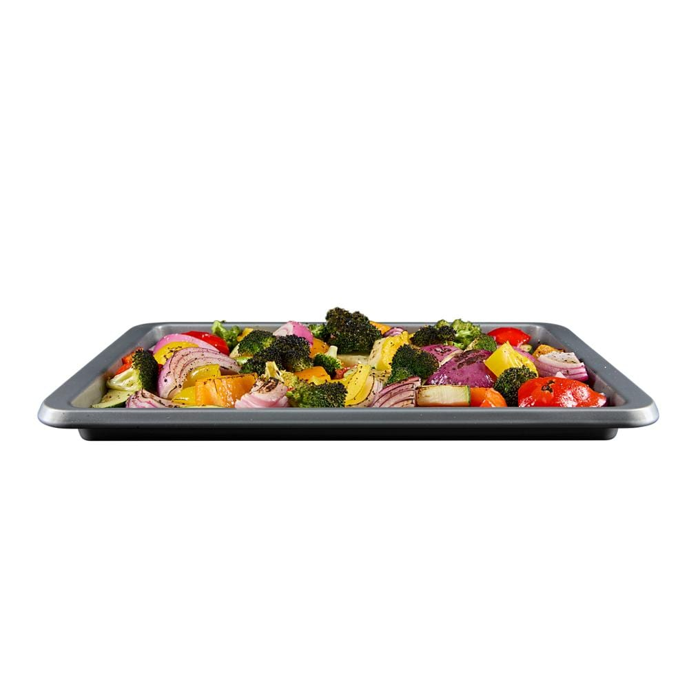 Tray of mixed seasoned vegetables including broccoli, red onion, and bell peppers ready for air frying or roasting