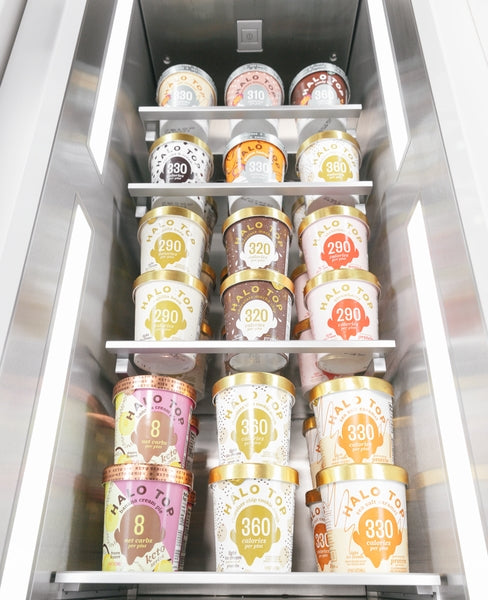 Open stainless steel built-in freezer column stocked with various Halo Top ice cream pints in Refrigerators and Kitchen collections