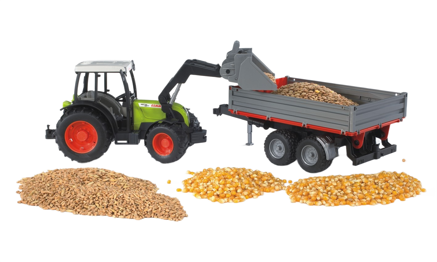 Toy tractor with front loader dumping grains into a gray trailer beside scattered piles of grain for play and display