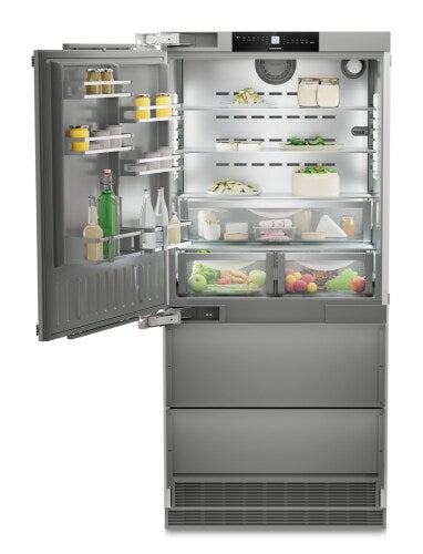 Built-in stainless steel refrigerator/freezer with open door displaying organized shelves and fresh food in kitchen appliances collection