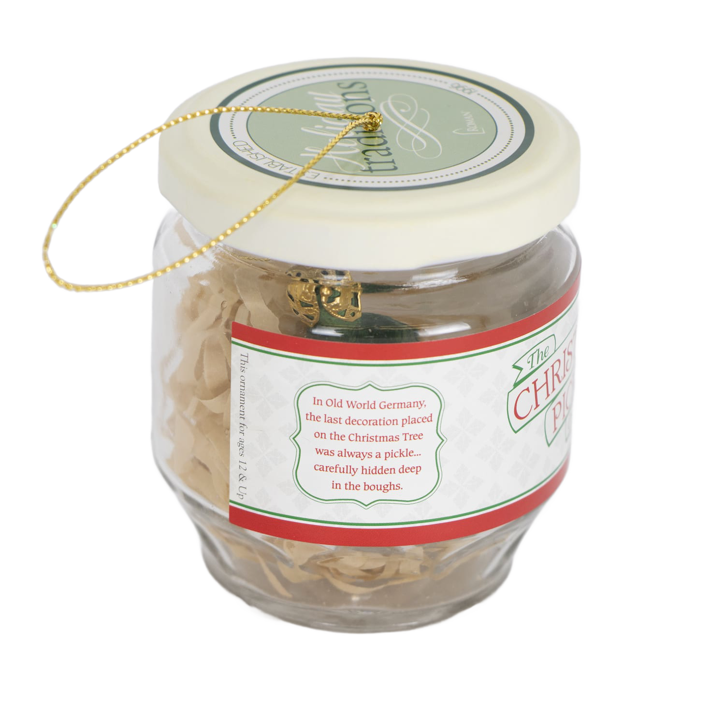 Small glass jar with decorative label holding a green Christmas pickle ornament and gold hanging string