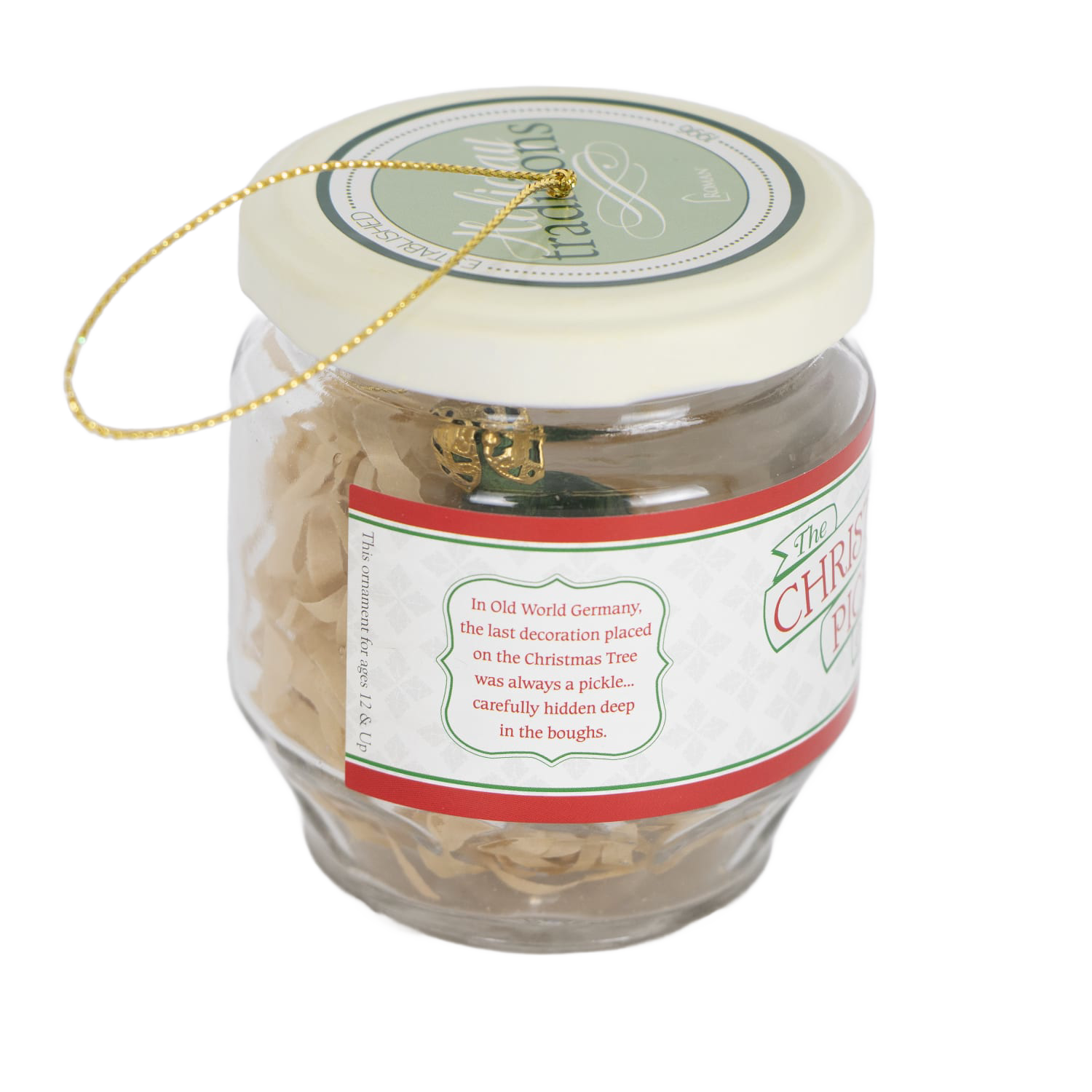 Small glass jar with decorative label holding a green Christmas pickle ornament and gold hanging string