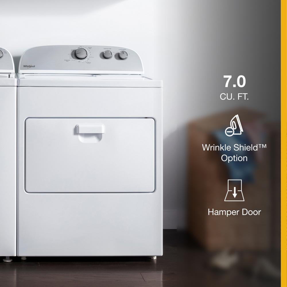 White top load gas dryer with control knobs, wrinkle shield option, and hamper door in laundry room setting