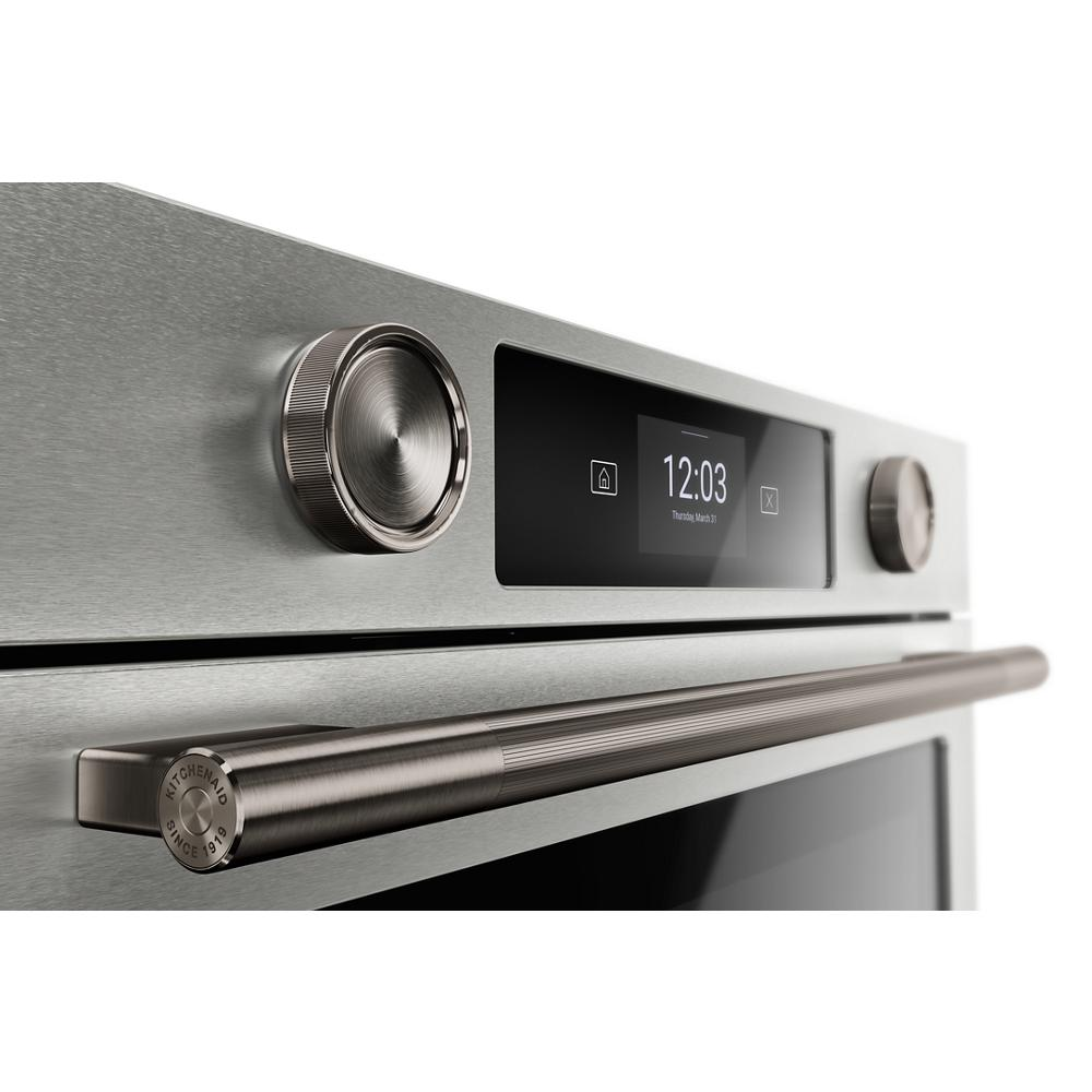Close-up of stainless steel smart electric wall oven control panel with LED touchscreen and brushed handle