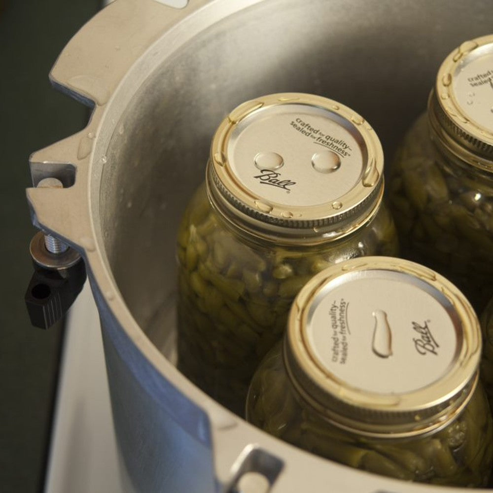 Aluminum pressure canner open with mason jars filled with green beans inside in Kitchenware collections