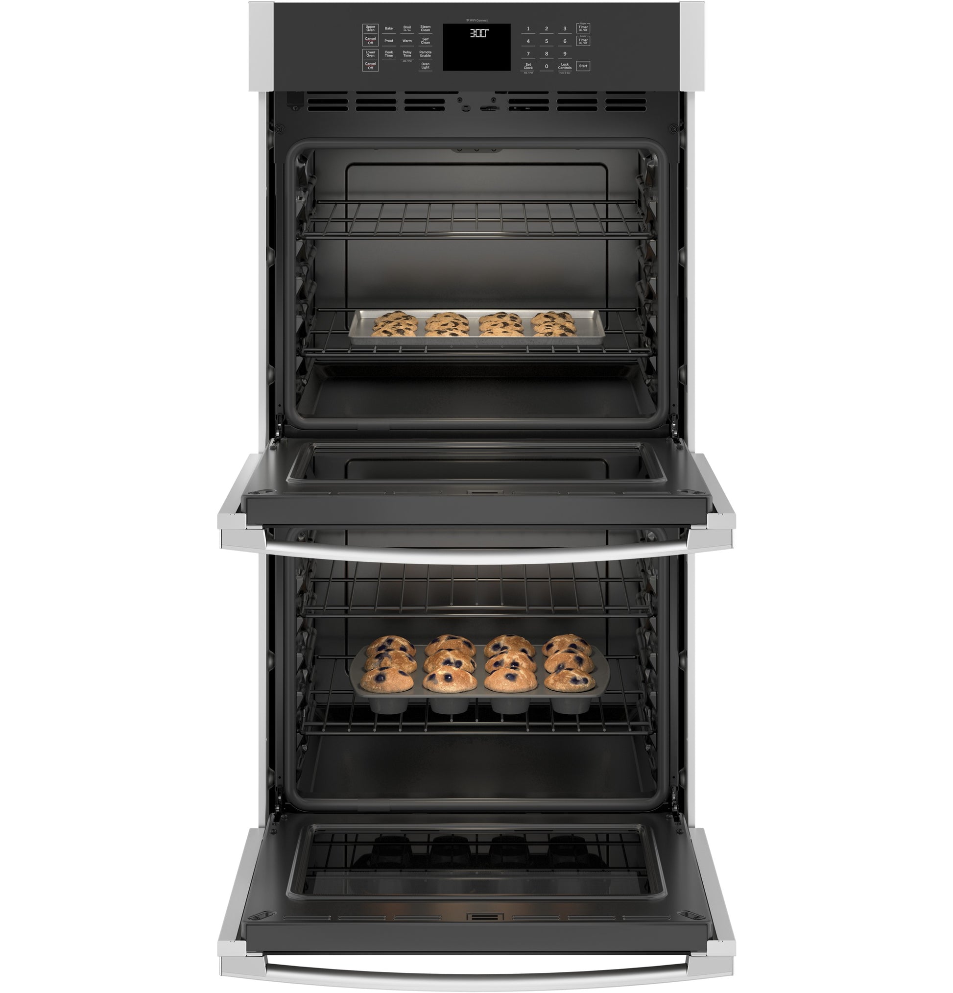 Open stainless steel double wall oven from kitchen appliances with baking trays of cookies inside both ovens
