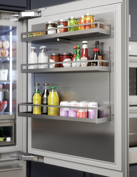 Open refrigerator door showing organized stainless steel interior shelves stocked with beverages and condiments