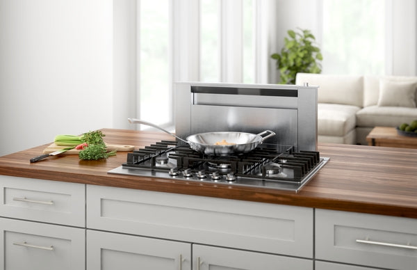 36-inch stainless steel cooktop installed in kitchen island with wooden countertop and retractable vent panel
