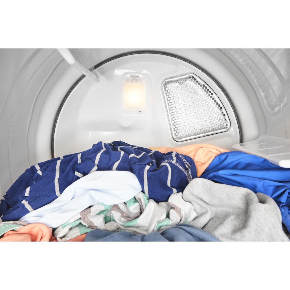 Interior view of a commercial-grade electric dryer drum with mixed colorful clothes inside from dryers collection