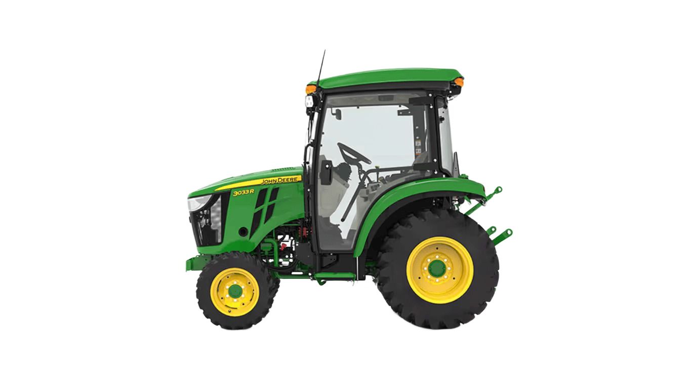 Green and yellow compact John Deere tractor with enclosed snow cab and standard seat for tools and home improvement tasks
