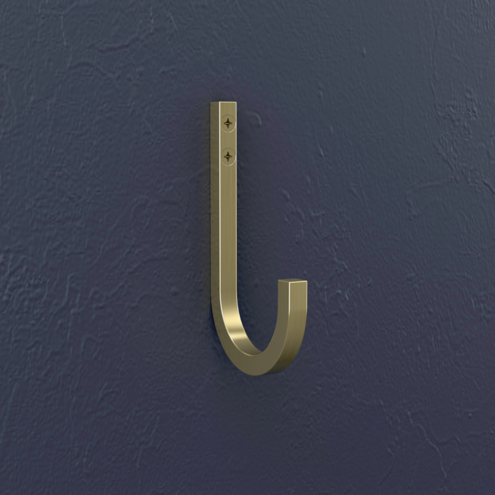 Brushed gold steel reed hook mounted on textured navy wall for storage and organization in home and garage projects