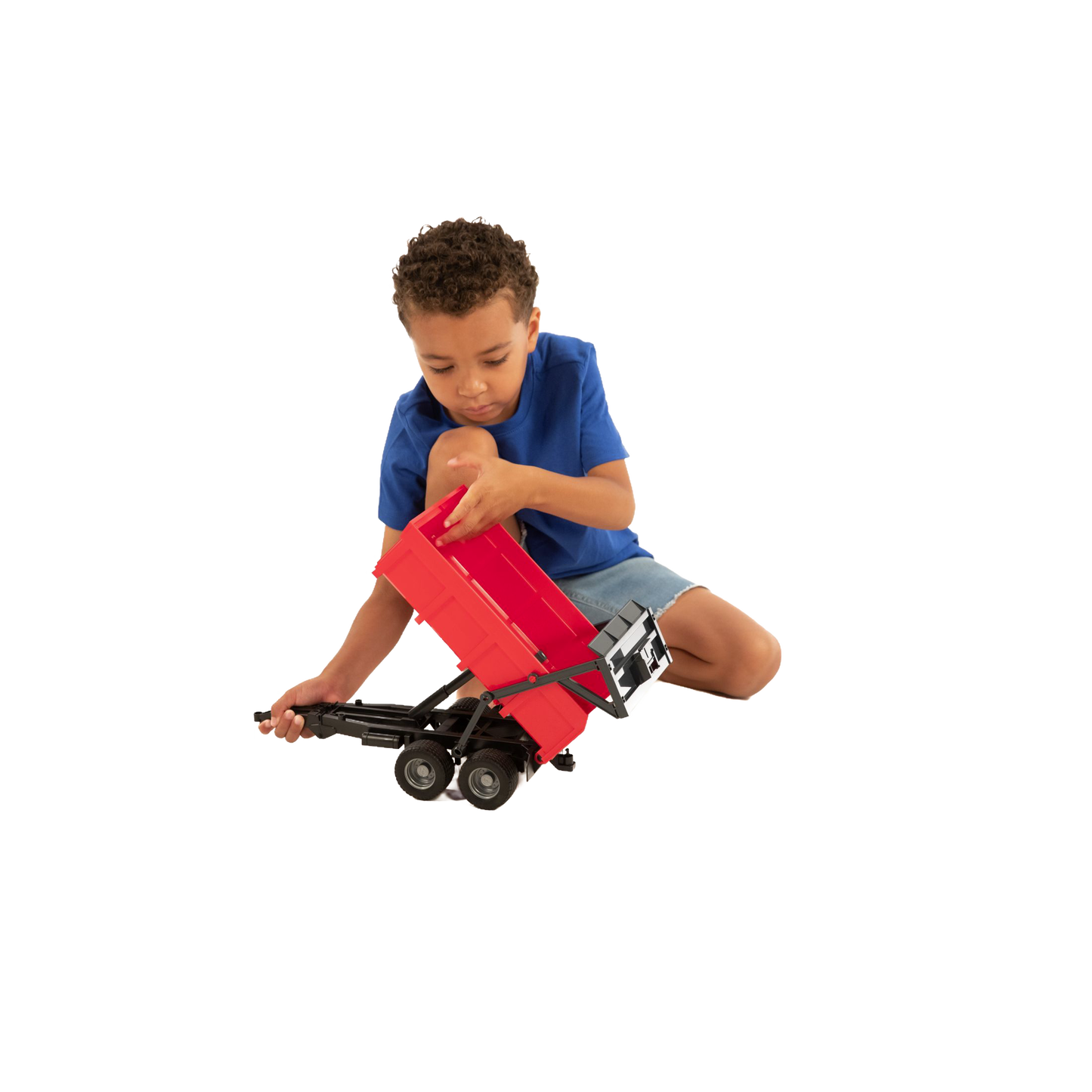 Young child playing with a red tipping trailer toy in Vehicles & Remote Controlled Toys and Bruder Toys collections