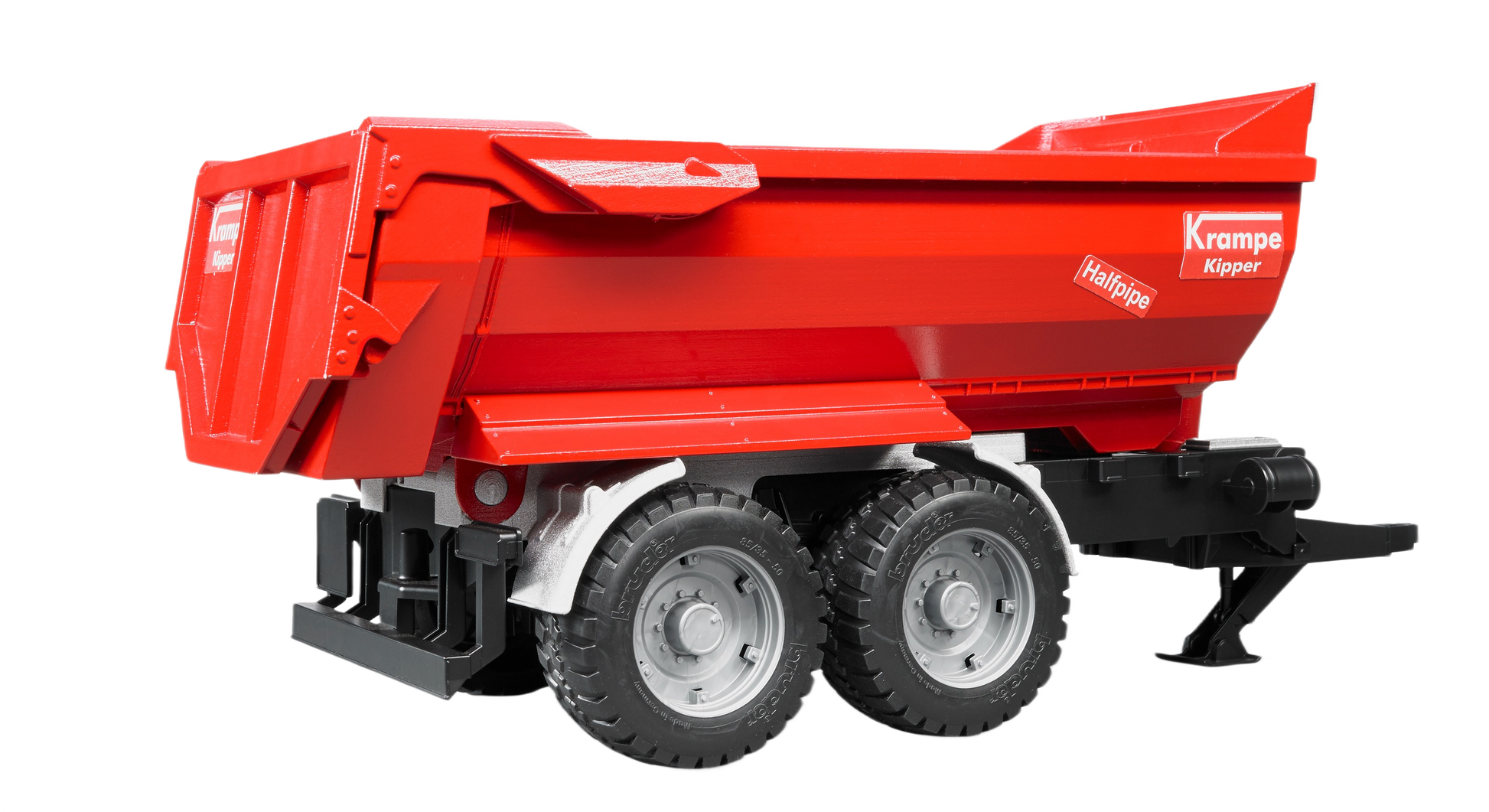 Red toy tandem axle halfpipe tipping trailer with black chassis and detailed wheels for realistic model display or play