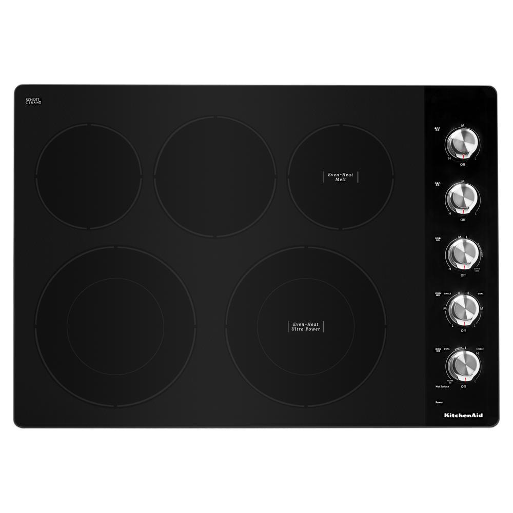 Top view of a black electric cooktop with five heating elements and silver knob controls from KitchenAid collection