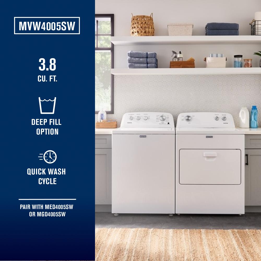 Laundry room with white top load washer with deep fill and matching dryer under white shelves in appliances collection