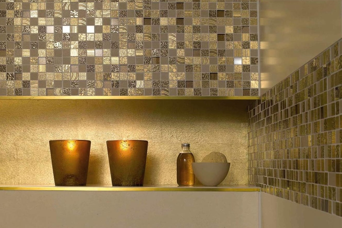 Interior corner with gold-toned mosaic tile backsplash and accent shelf with decorative lighting for home improvement