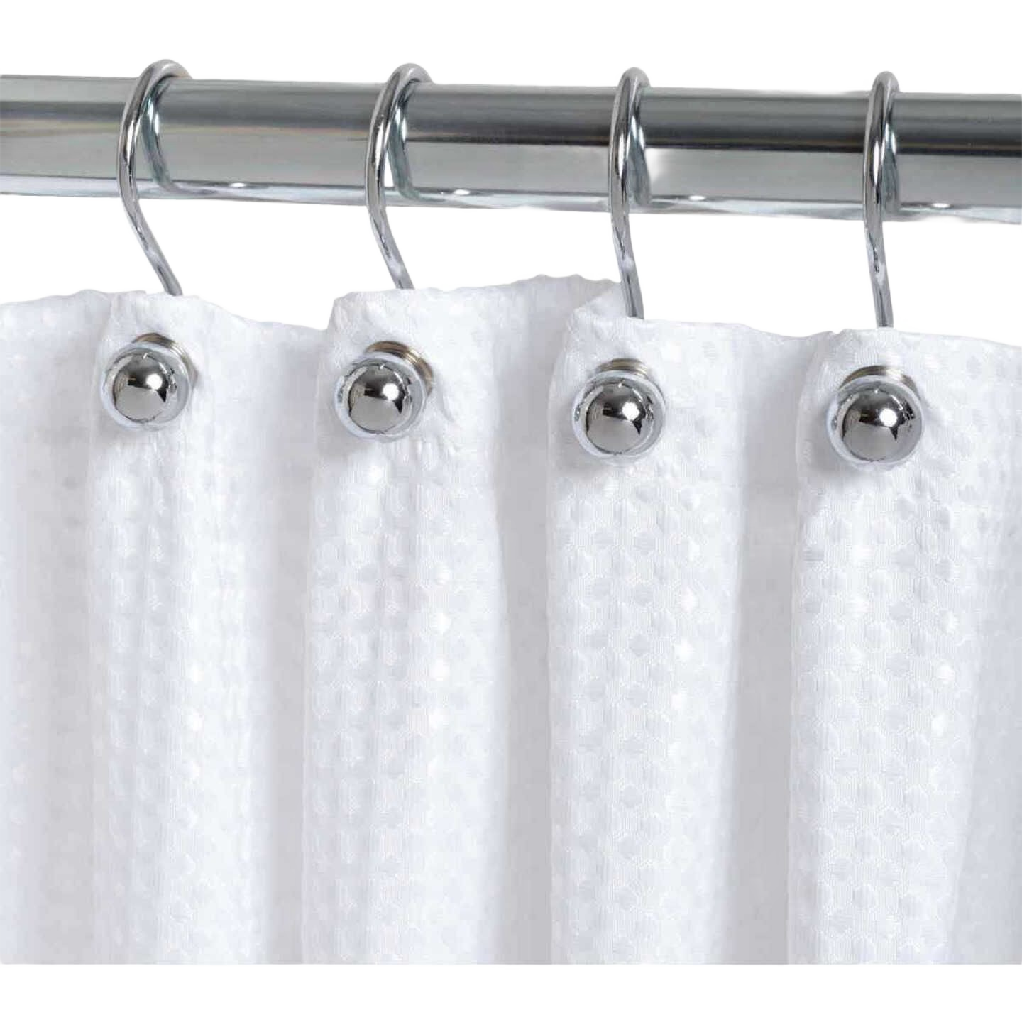 Chrome ball end shower curtain hooks hanging on polished metal rod with white textured shower curtain