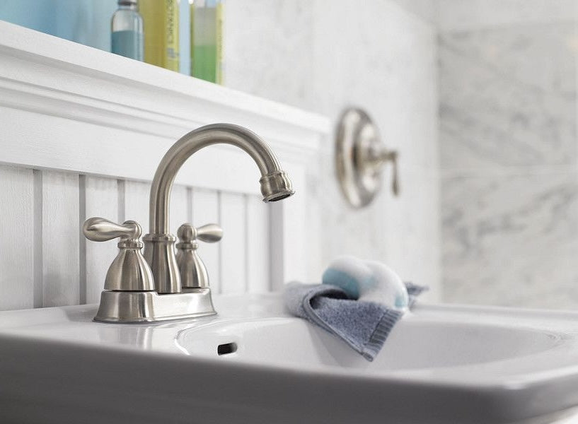 Brushed nickel two-handle high-arc bathroom faucet installed on white sink for home improvement use