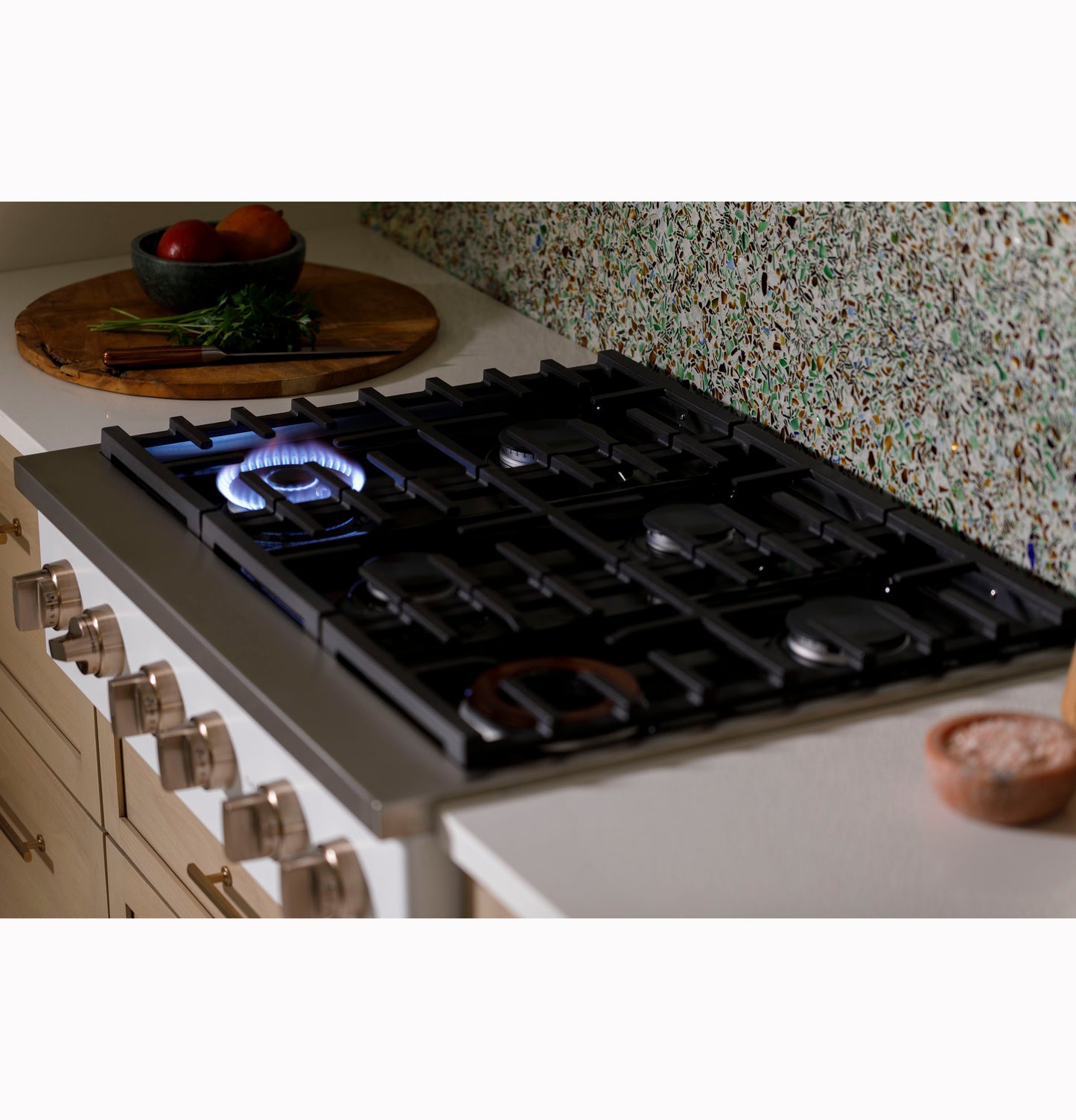 Commercial-style gas rangetop with six burners on kitchen counter in modern home improvement setting