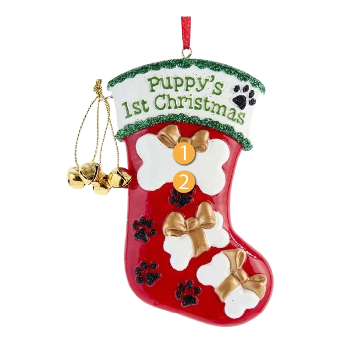 Red Christmas stocking ornament with white bone shapes, gold bows, black paw prints, and jingle bells for puppy’s first Christmas decoration