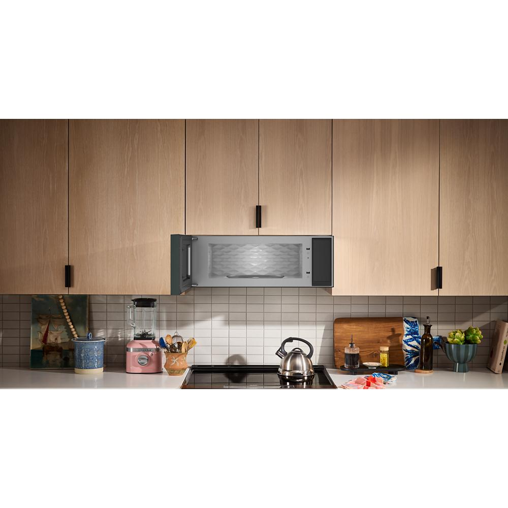 Modern stainless steel low profile microwave hood above stove with kitchenware and home improvement setting
