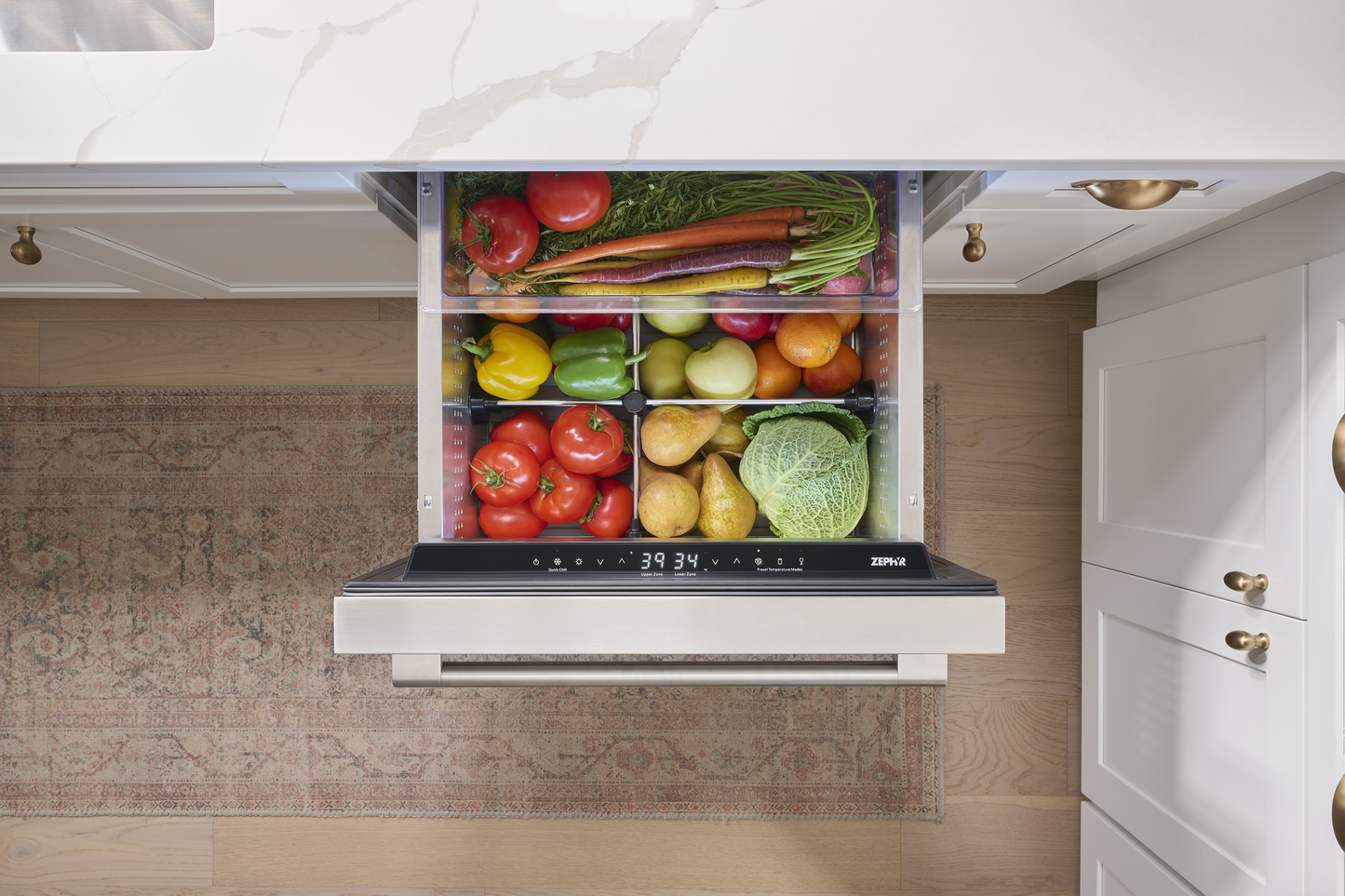 Under-counter stainless steel refrigerator drawer open with fresh vegetables and fruits in kitchen appliances collection