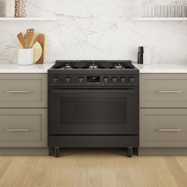 36-inch black stainless steel freestanding gas range with digital display and heavy-duty control knobs between gray cabinetry