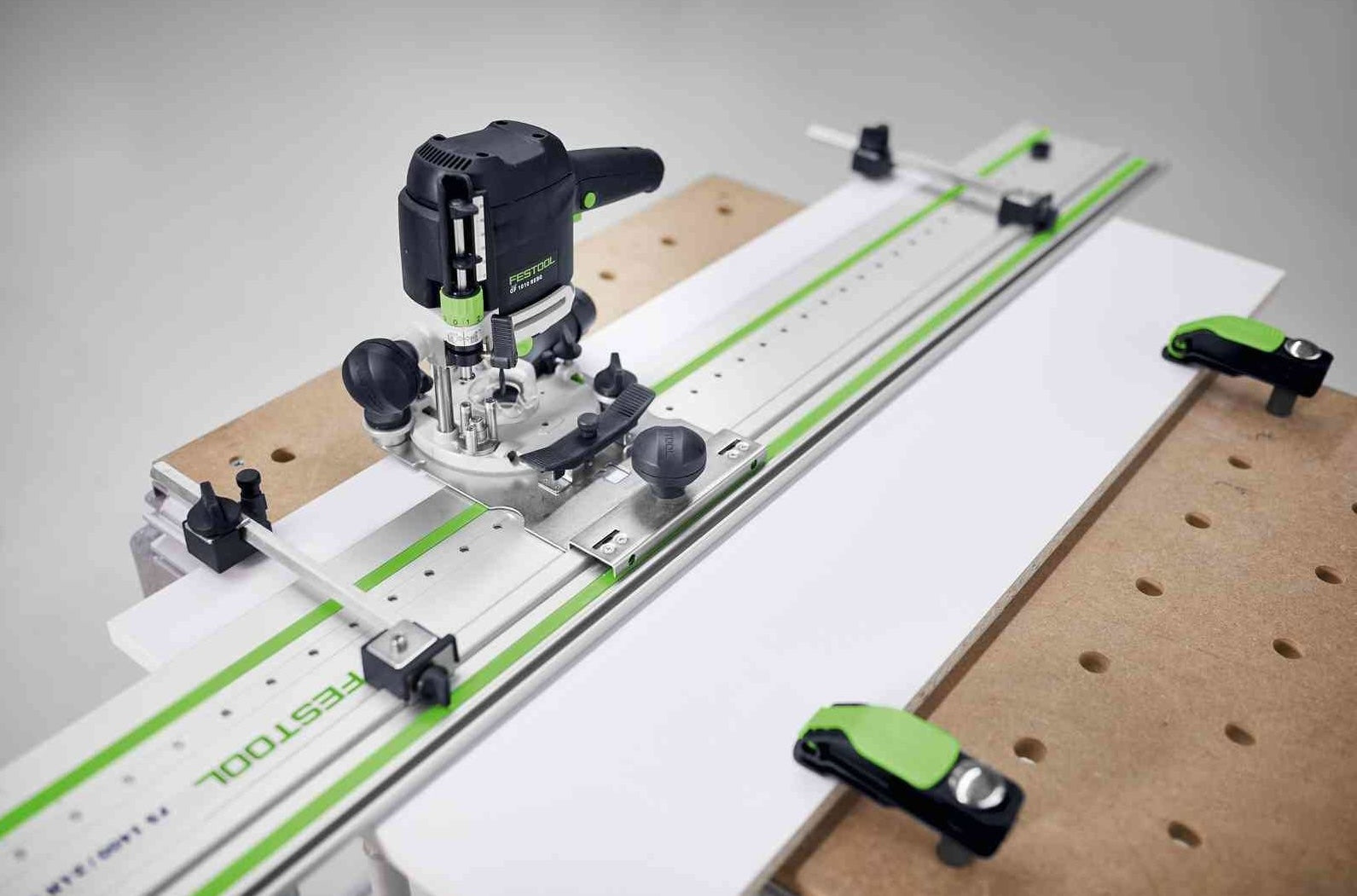 Festool LR 32-SYS hole drilling guide clamped to workbench with router tool for cabinet making projects