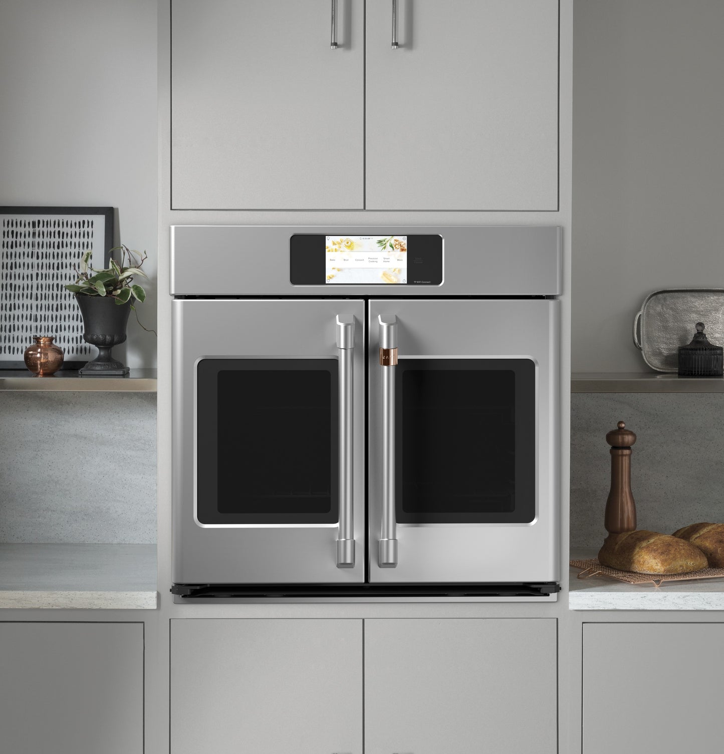 Stainless steel smart built-in French-door single wall oven with touchscreen in modern kitchen setting