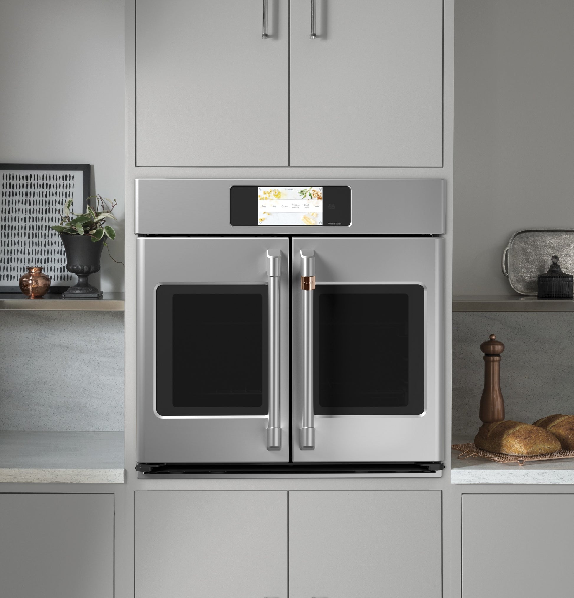 Stainless steel smart built-in French-door single wall oven with touchscreen in modern kitchen setting