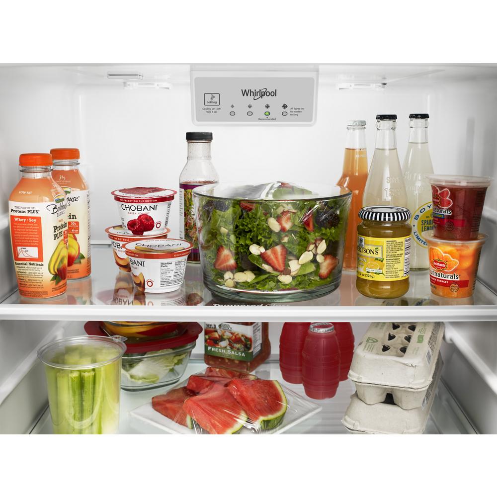 Interior view of Whirlpool refrigerator stocked with fresh produce, beverages, and dairy in kitchen appliances collection