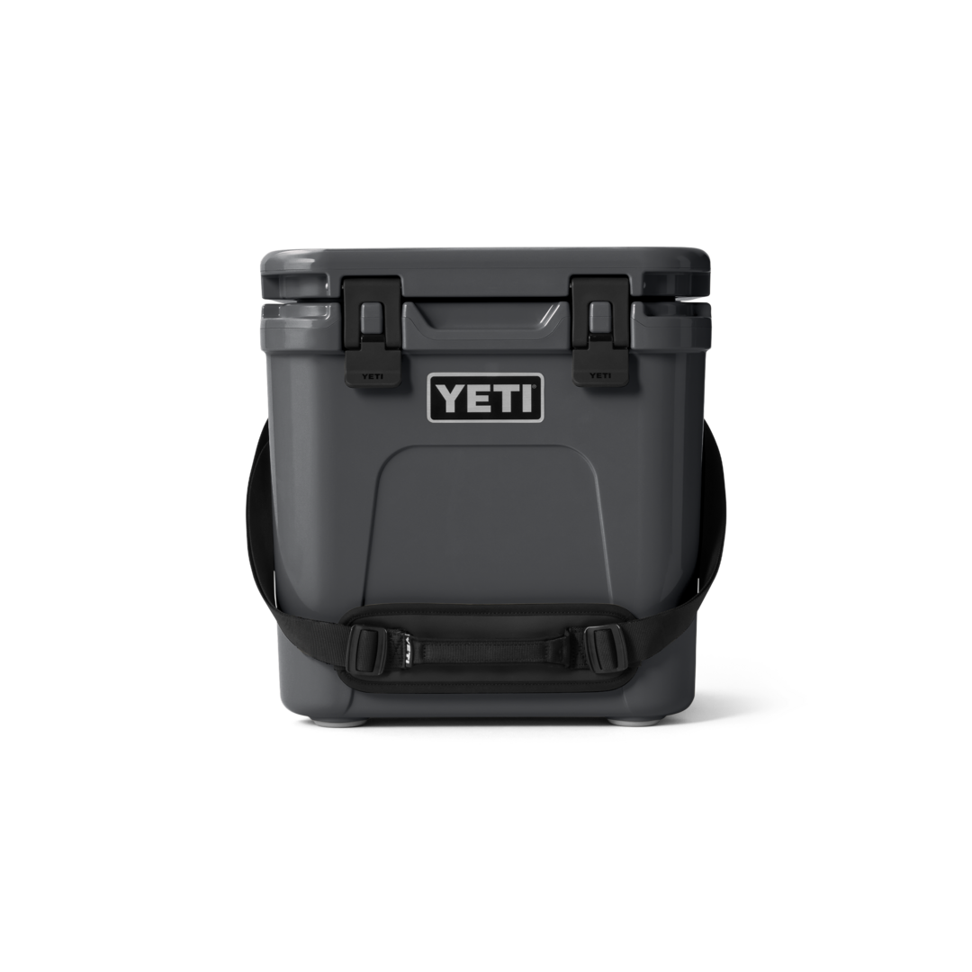 Gray durable hard cooler with secure latches and shoulder strap for food storage and outdoor organization collections