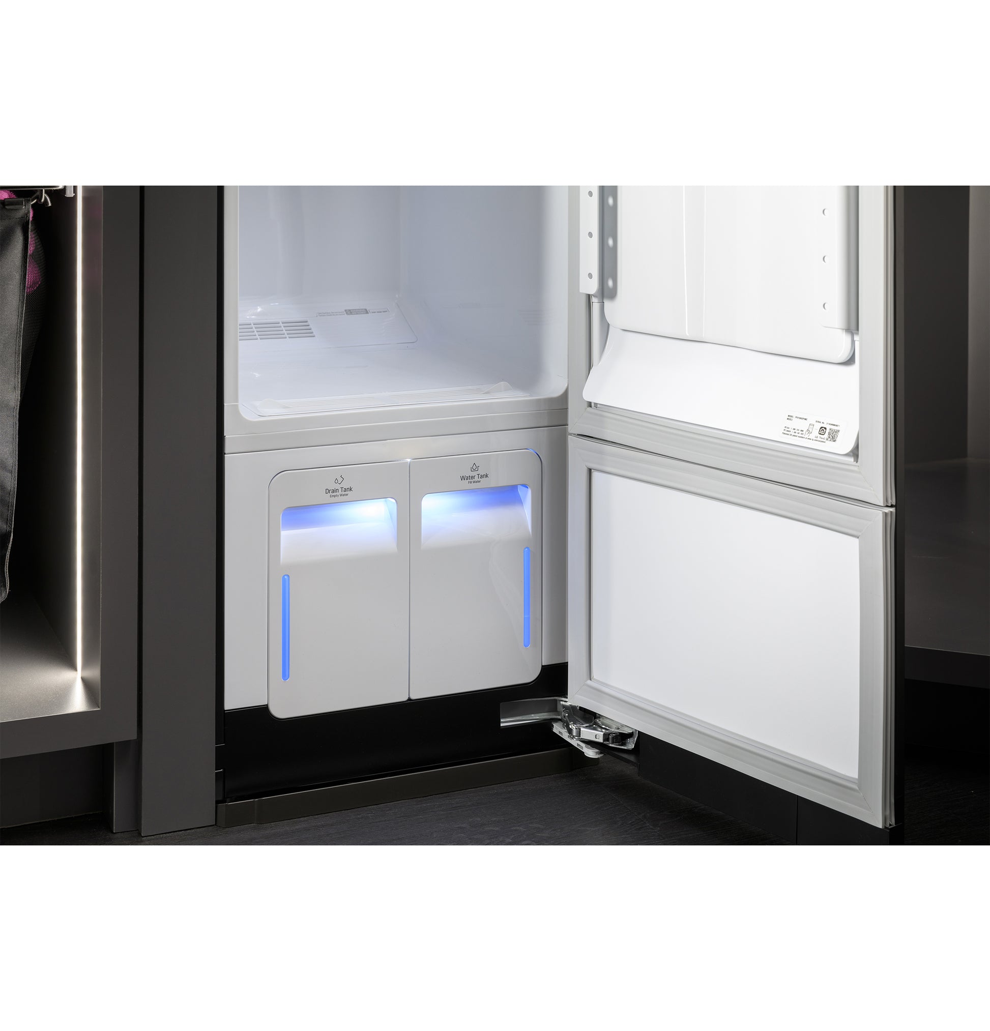 Open GE Profile Steam Closet with illuminated compartments in a modern appliance laundry center setting