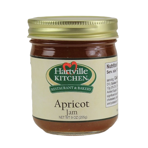 Glass jar of Hartville Kitchen apricot jam with gold lid and cream label for jams and jellies collection