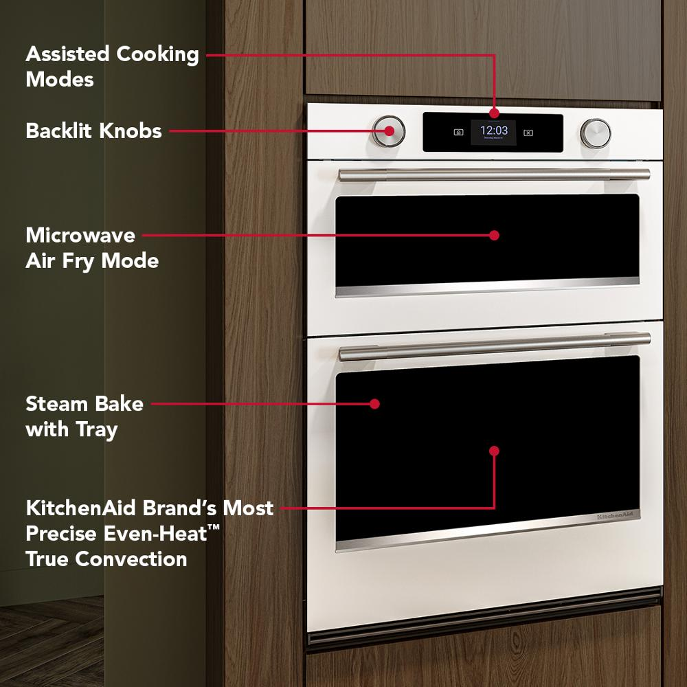 White 30-inch smart electric combo wall oven with touchscreen, backlit knobs, and labeled cooking mode features in kitchen setting