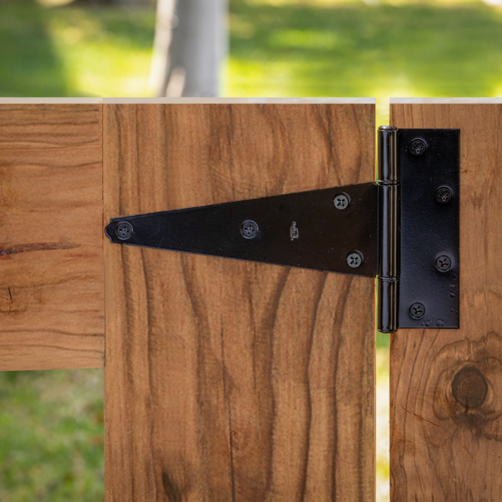 Black heavy-duty 8-inch tee hinge installed on wooden gate in door hardware and slide and hinges collections under $50