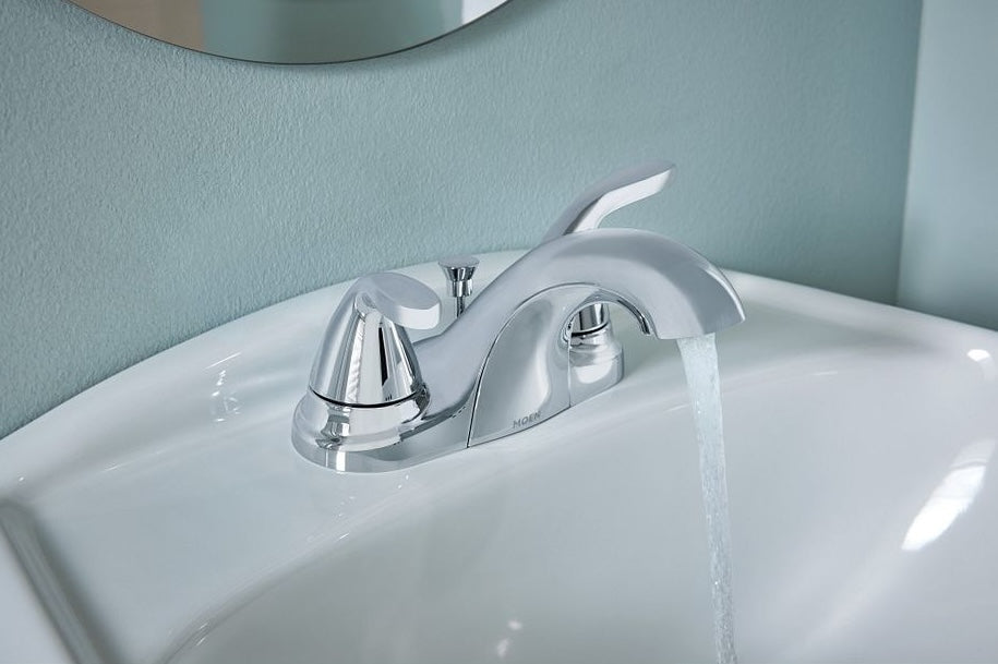 Chrome two-handle low arc faucet installed on bathroom sink with water flowing, ideal for home improvement projects
