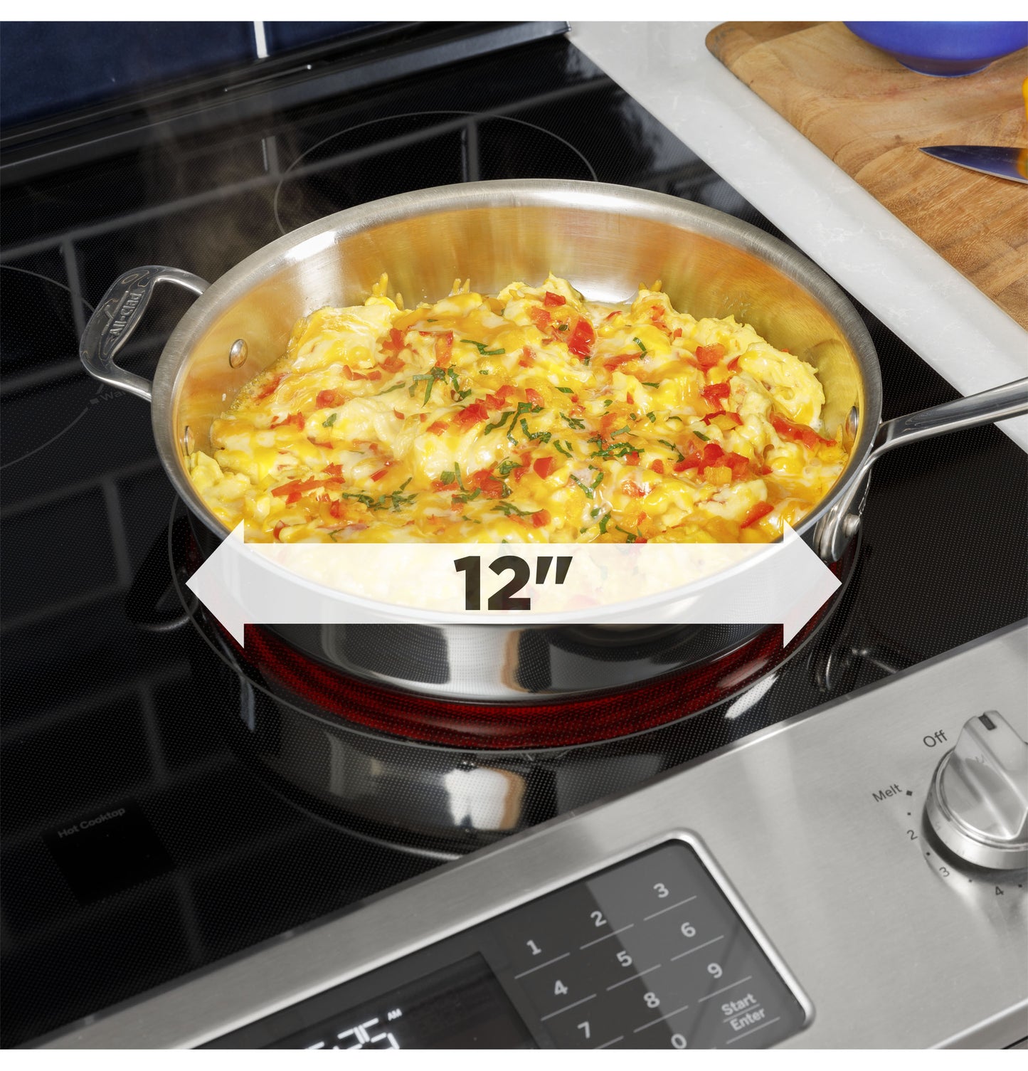 12-inch stainless steel skillet cooking scrambled eggs with vegetables on electric cooktop range from Ranges collection