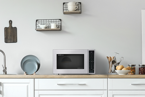 Stainless steel countertop microwave with digital controls in a modern kitchen from appliances collection
