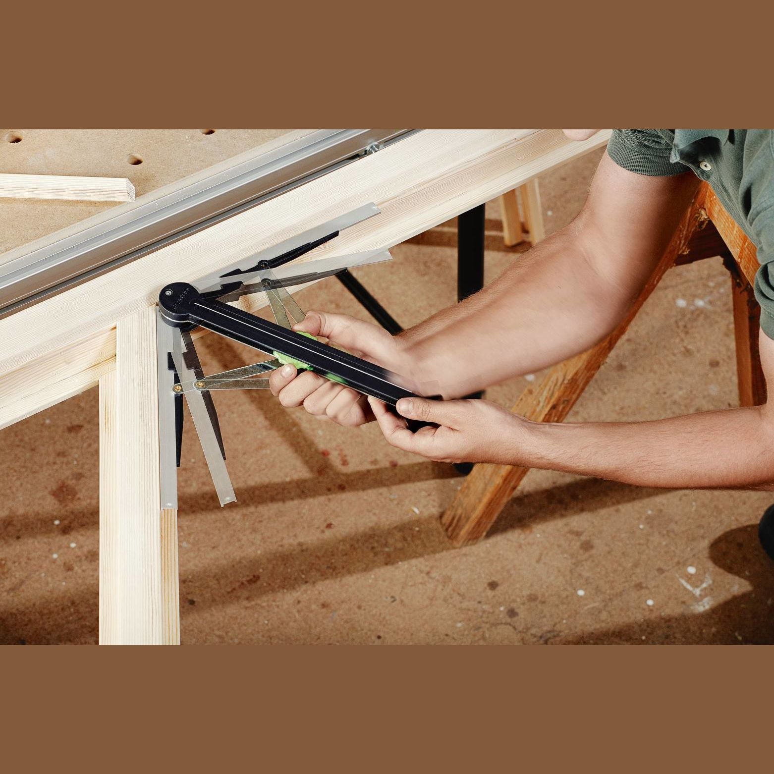Person using black and metal angle transfer tool on wood frame for saw accessories in home improvement tools collections